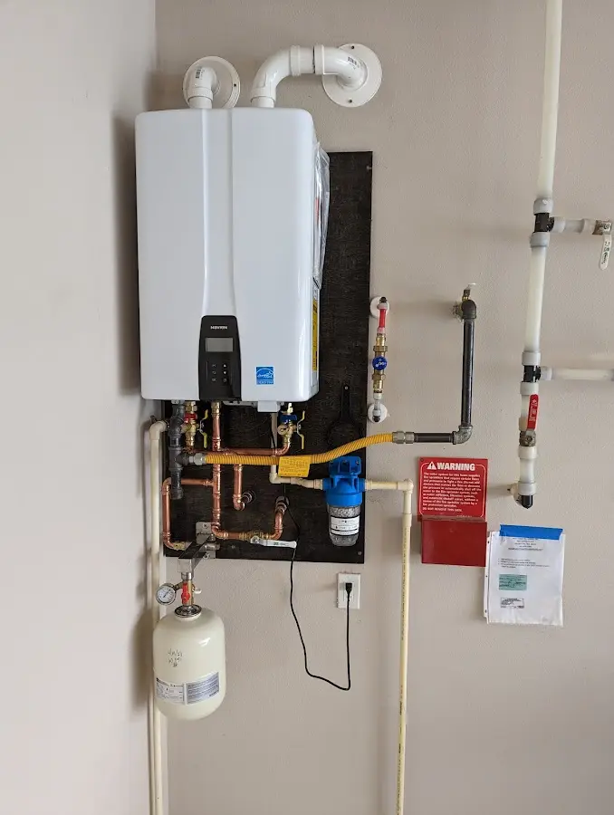 Professional plumber installing copper piping in a County Center home